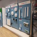 Thorn Eco lighting product display wall featuring ceiling lights, emergency exit signs, and LUCI Association LightLinks branding
