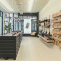 Modern retail store interior with phone accessories displayed on wall shelving and central display units.