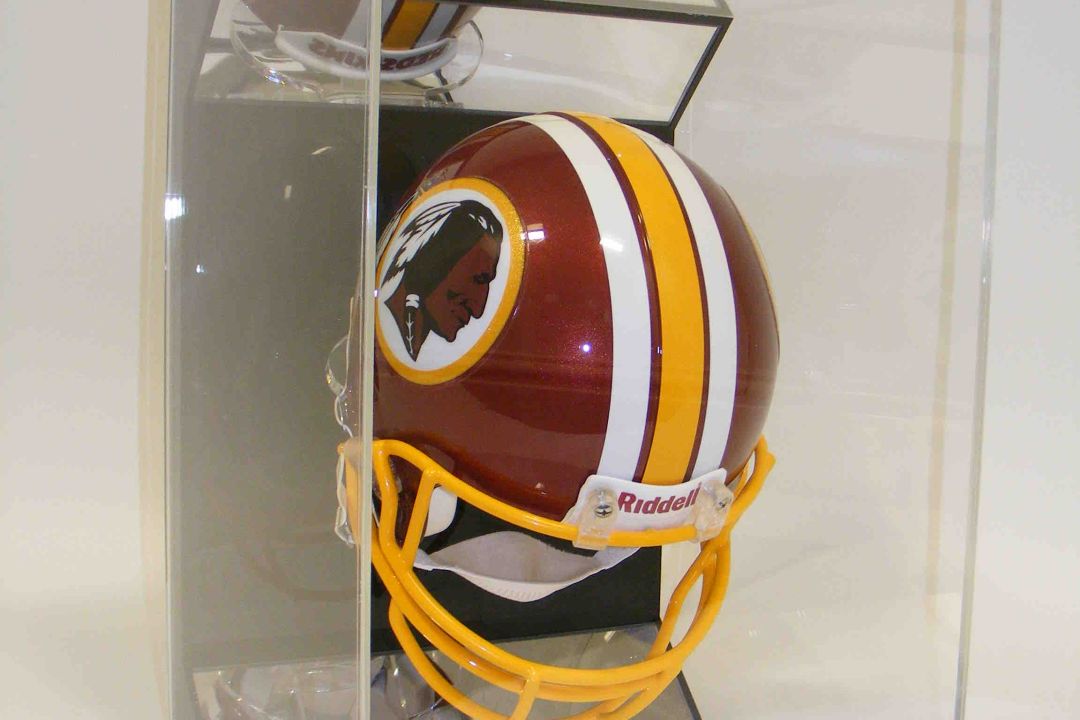 Riddell mini American football helmet in a clear acrylic display case against a white background